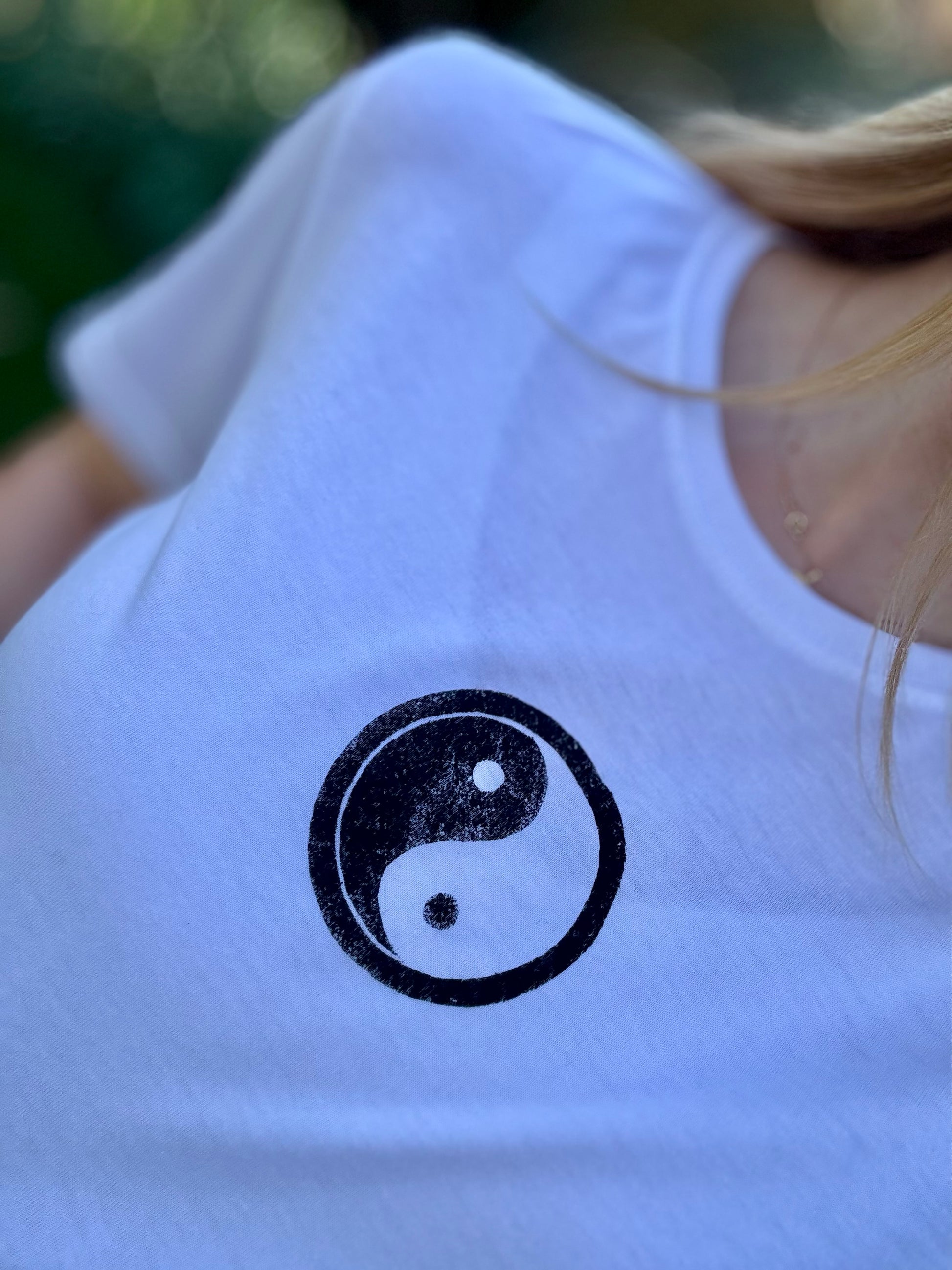 Close Up of Yin Yang Handpainted Design on White Positive Slogan Tee