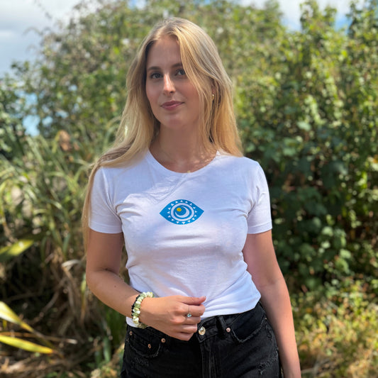 Woman wearing a white t-shirt with a blue logo outdoors